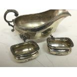 A silver plated gravy boat and a pair of silver sa