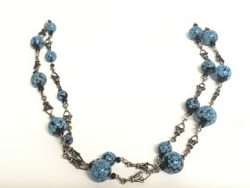 An Egyptian revival silver bead necklace, postage