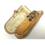A cased Antique amber gold & garnet cheroot holder