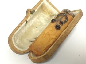 A cased Antique amber gold & garnet cheroot holder