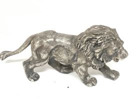 A detailed solid cast silver sculpture of a male l