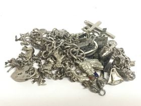 A collection of various silver charms and a bracel