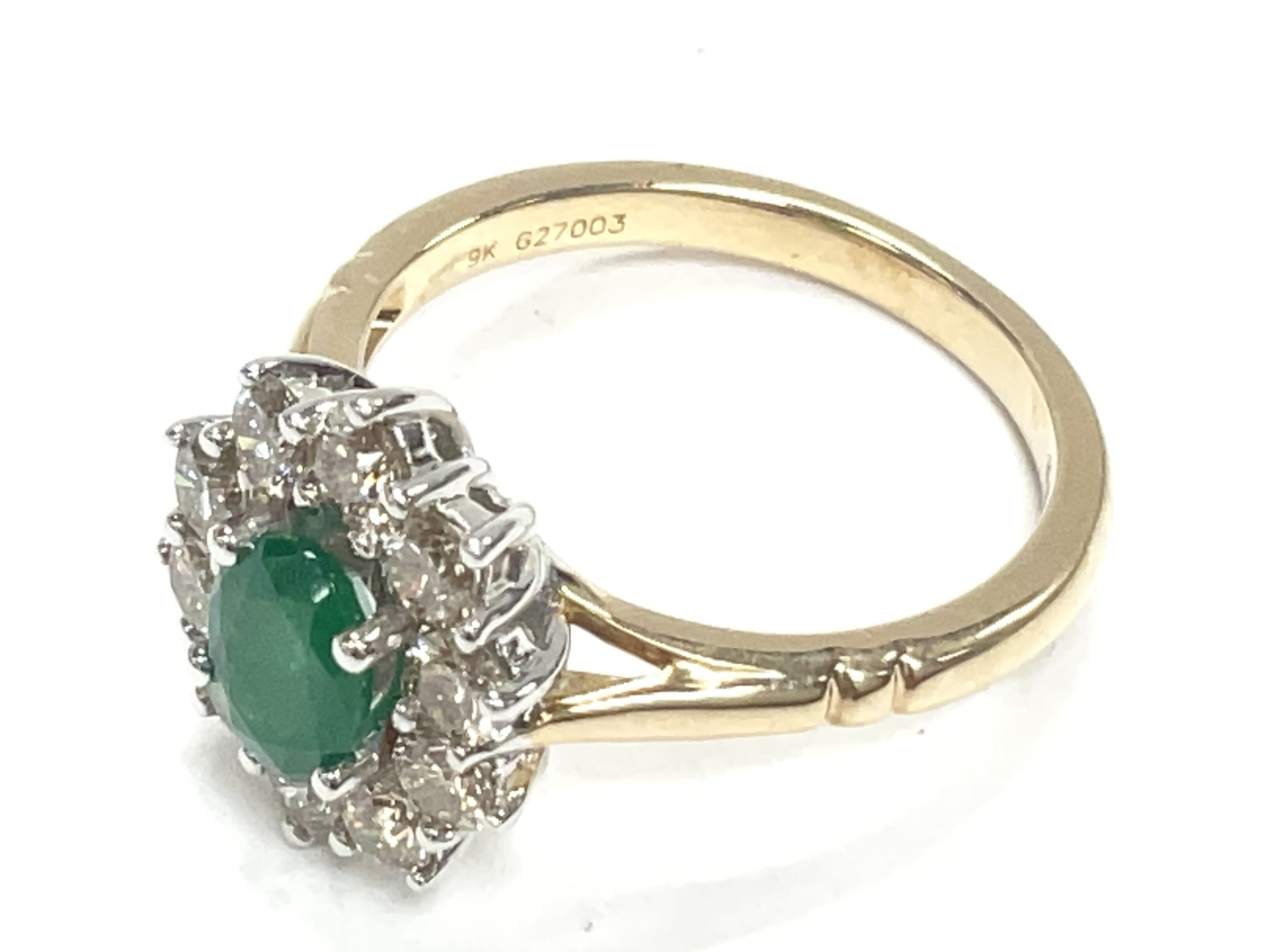 Oval emerald and diamond cluster ring set in 9ct w