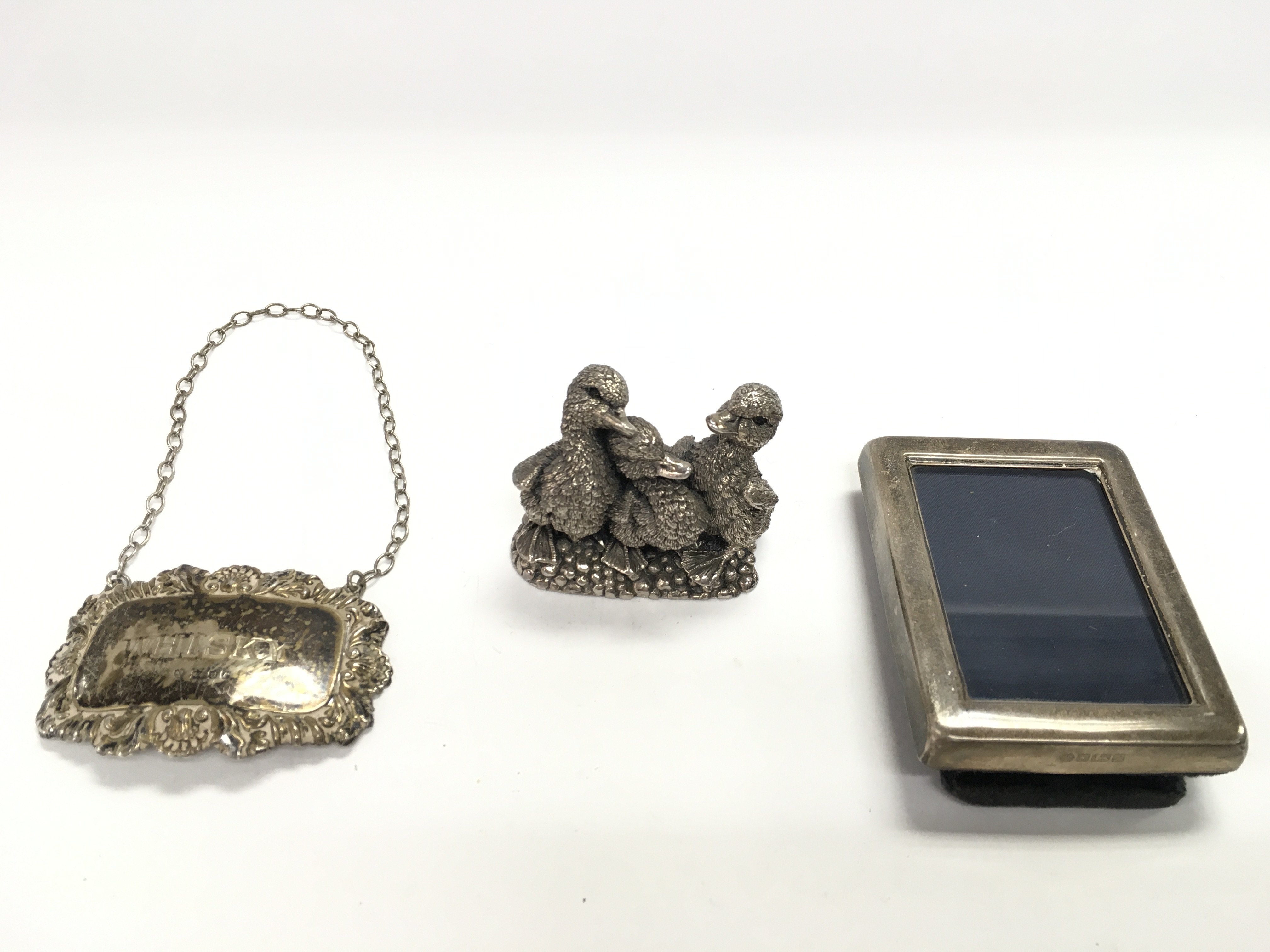 Three silver items including a small silver frame