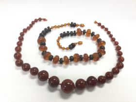 Two amber necklaces, one with graduating beads. To