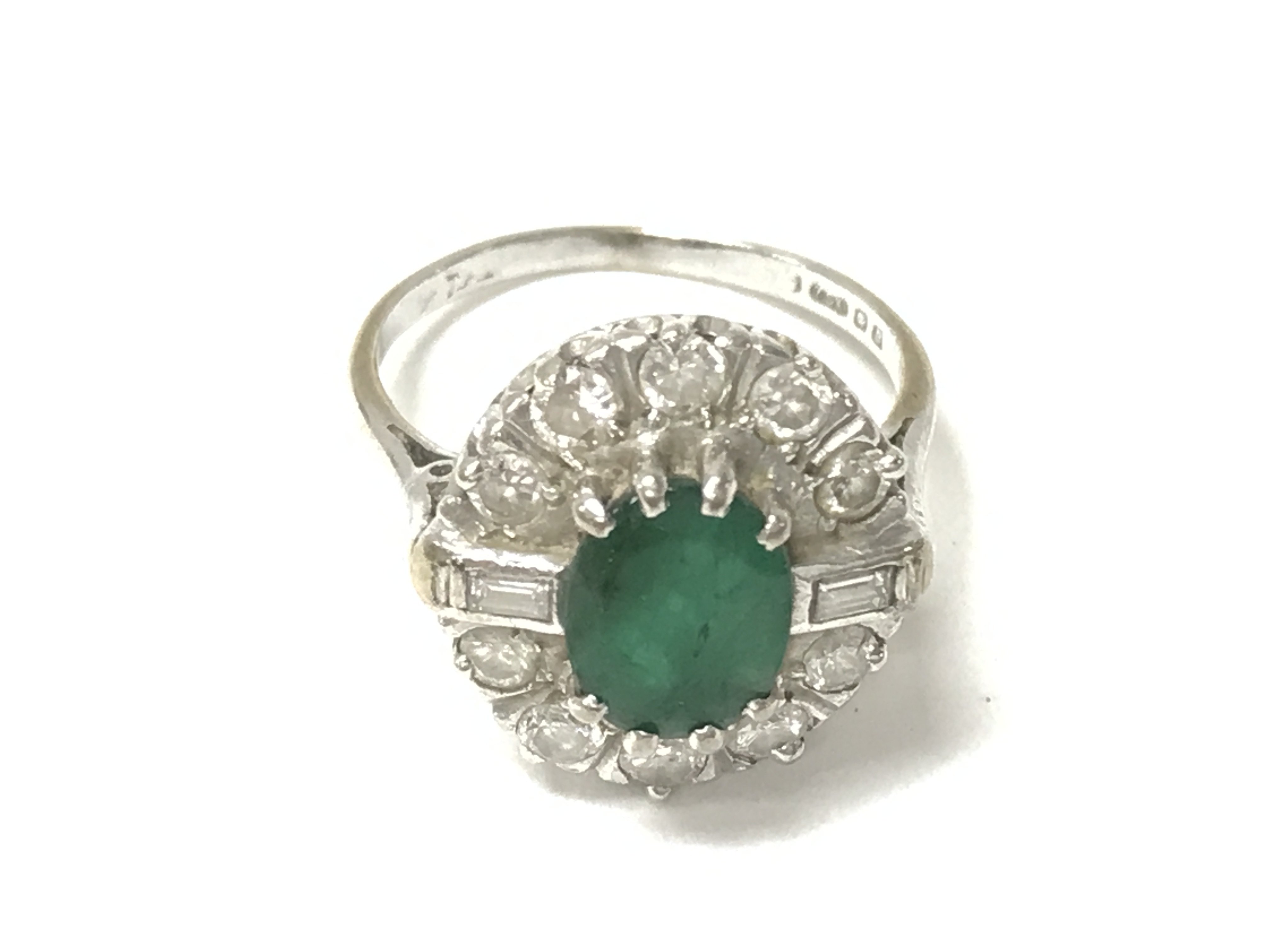 An 18ct white gold emerald and diamond ring. 5.30g