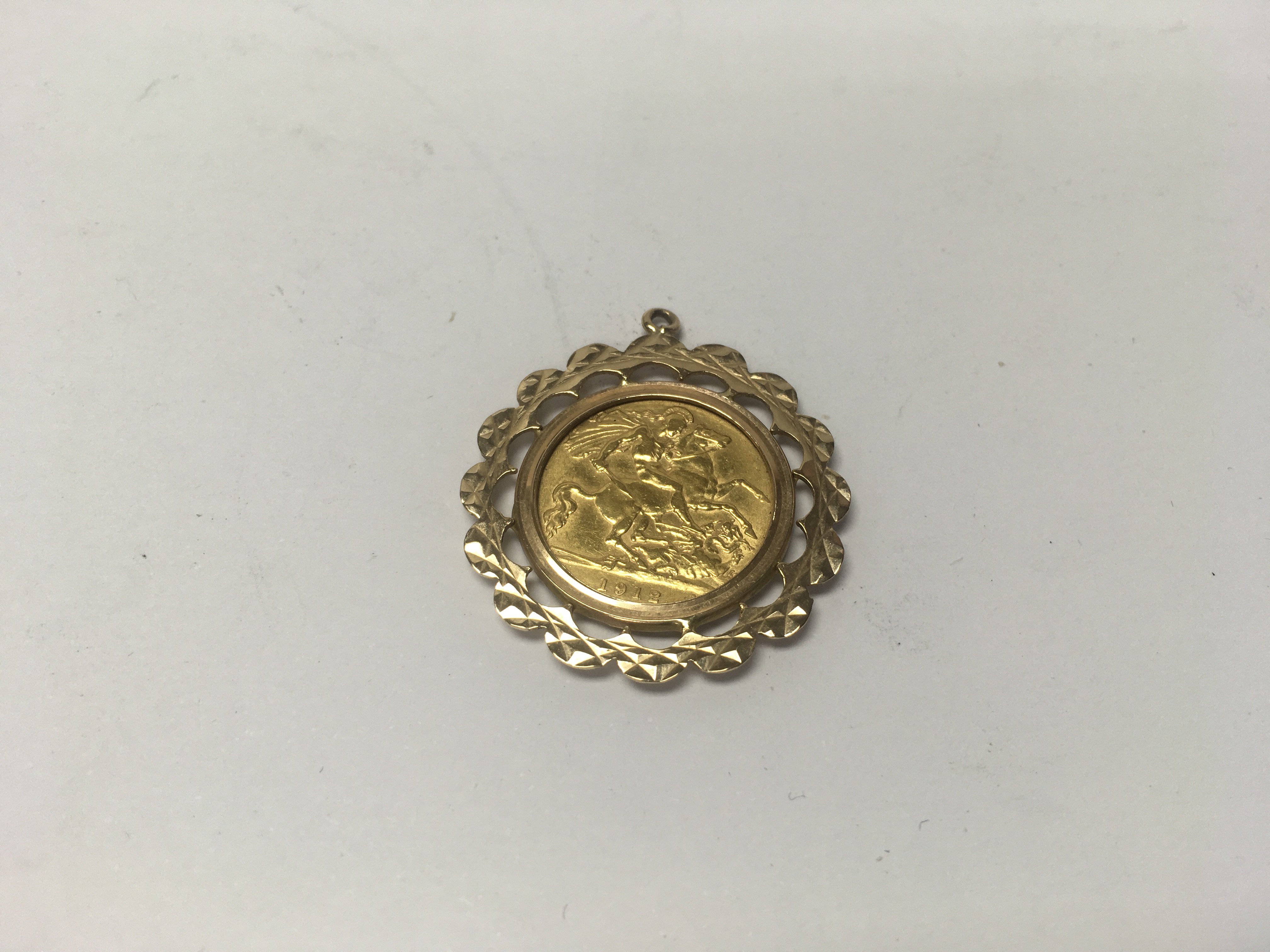 A half sovereign coin in a 9ct gold pendant mount.