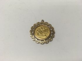 A half sovereign coin in a 9ct gold pendant mount.