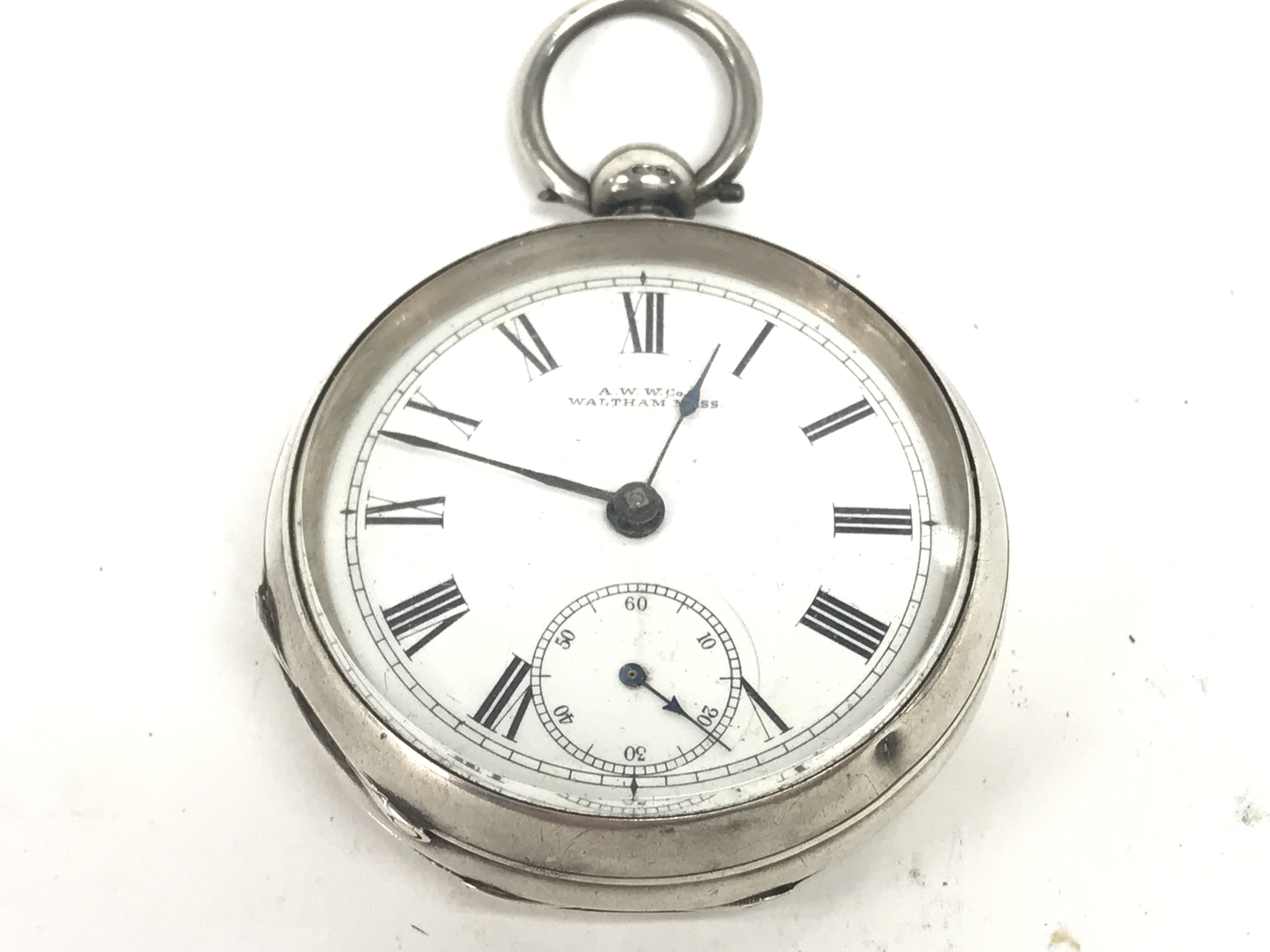 A silver Waltham pocket watch. Winds and runs. App