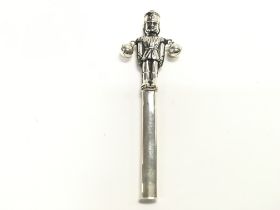 A silver rattle in form of a soldier. Approx 13cm.