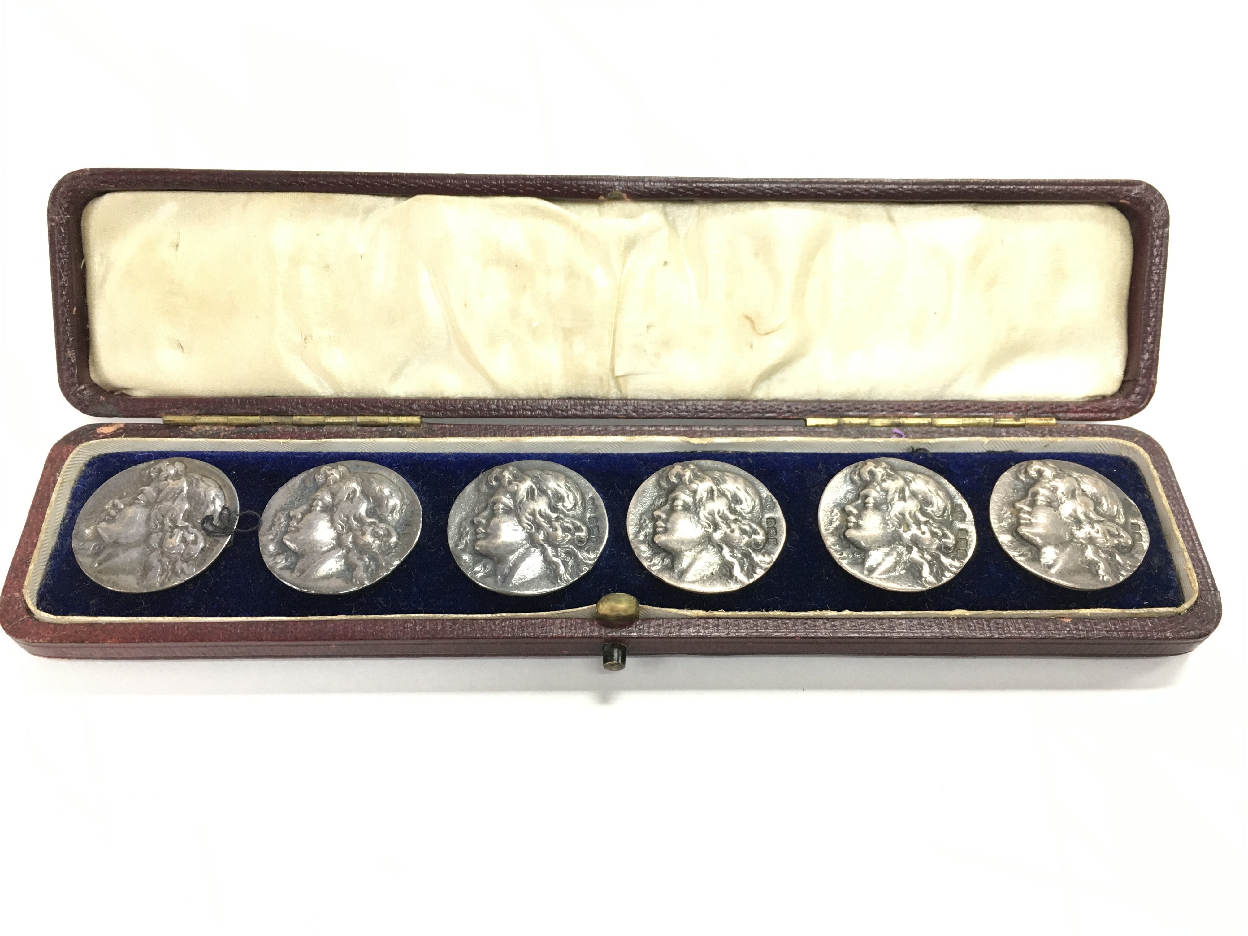 A boxed set of six silver art nouveau buttons.Post