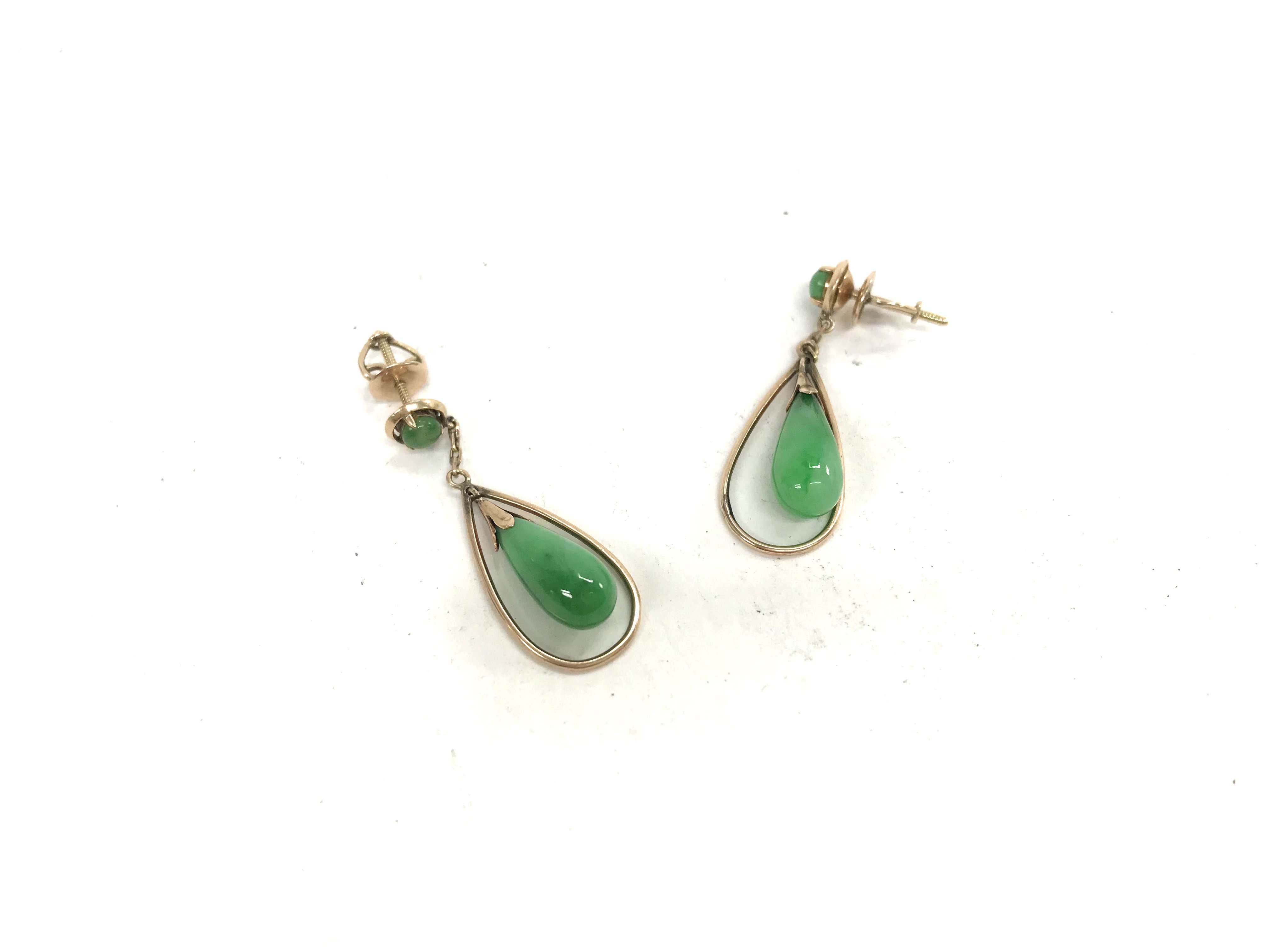 A 14ct gold pair of jade earrings. Approx weight 4