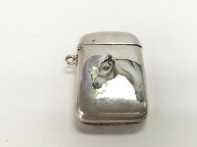 An enamelled silver vesta case. Postage A
