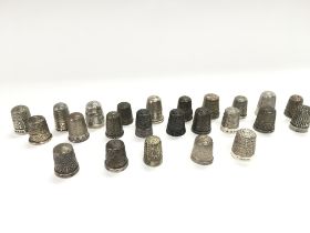 A collection of 24 silver thimbles.