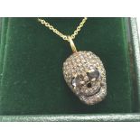 Diamond set skull pendant with black diamond eyes,