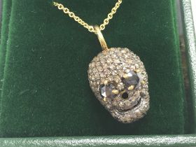 Diamond set skull pendant with black diamond eyes,