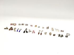A collection of 26 pairs of silver earrings. Posta