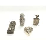 A collection of silver items including perfume bot