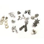 A collection of silver earrings. Postage category