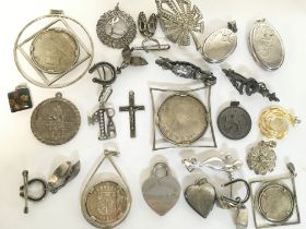 A collection of silver jewellery, including pendan