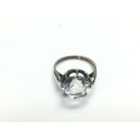 A silver ring set with a large clear stone, approx