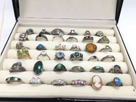 A collection of 36 silver rings set with assorted