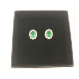Pair of 18ct white gold studs set with oval emeral