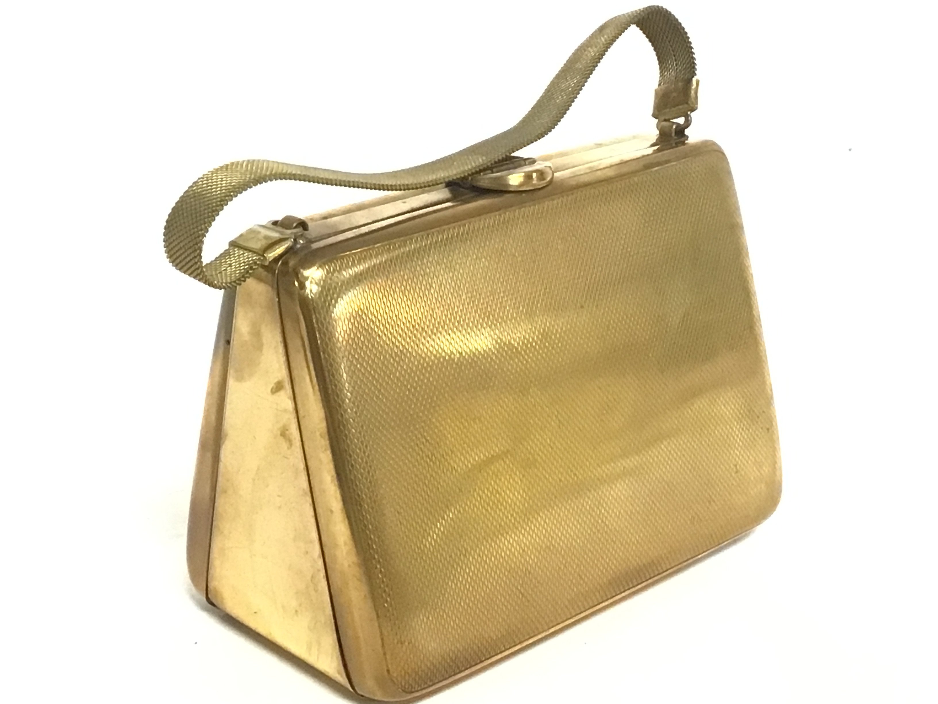 A vintage handbag design compact with makeup and a