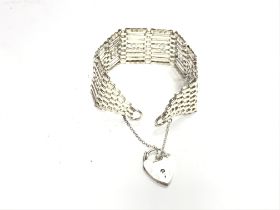 A silver gate bracelet with a heart padlock. 26g