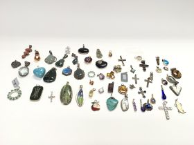 A collection of silver pendants approx 260g. Posta