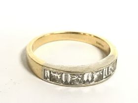 An 18 carat gold ring set with a single row of dia