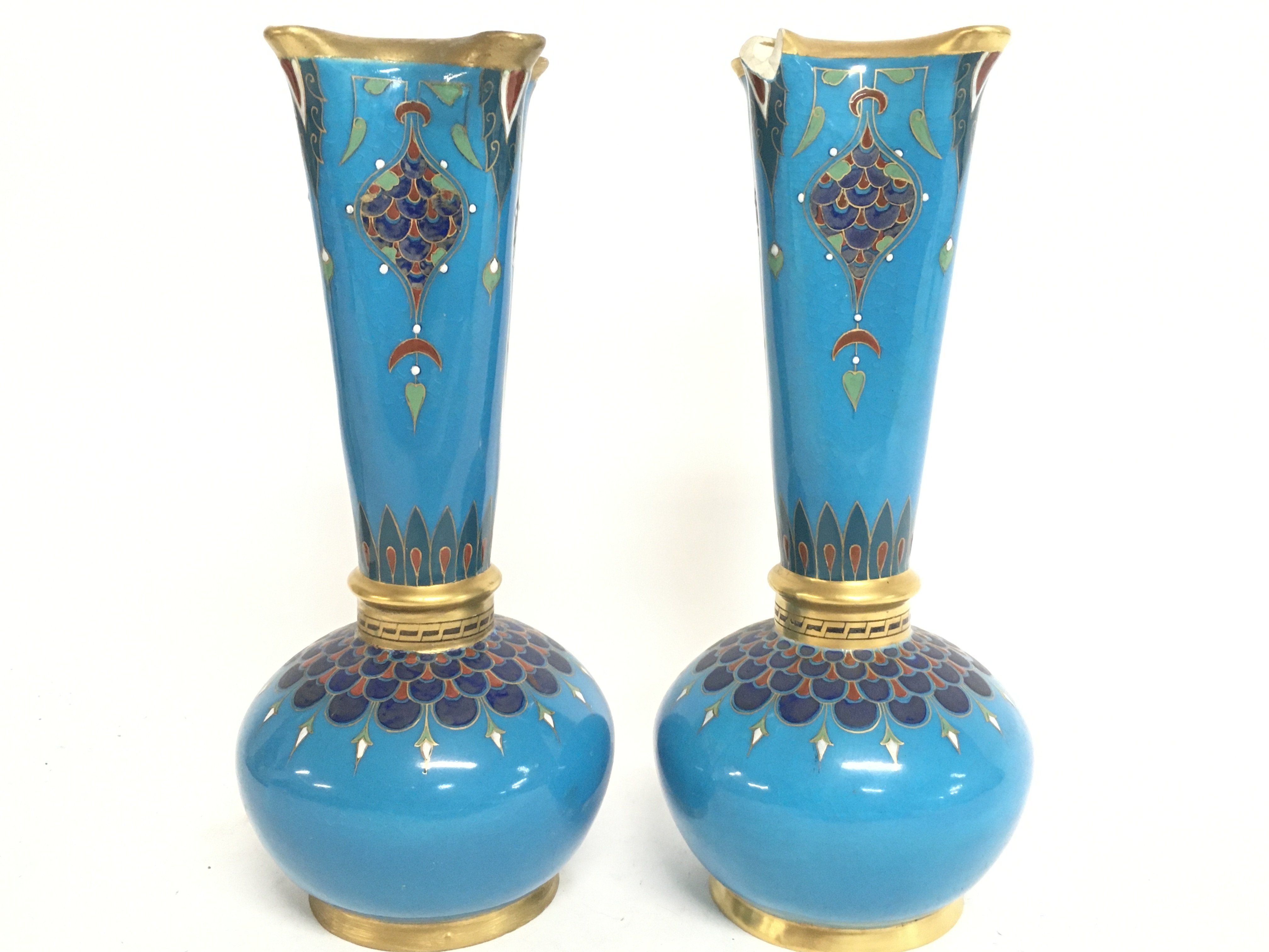 A pair of ornate blue and gilt Minton vases (damag