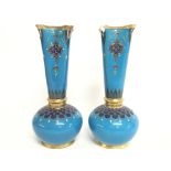 A pair of ornate blue and gilt Minton vases (damag