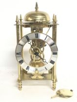 A Sewills skeleton brass mantle clock, 24cm tall a