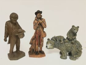 A wooden figure of a beggar, a Shepard and a bear
