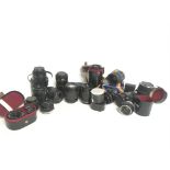 A collection of vintage camera lenses including To