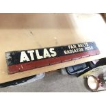 A long metal sign for Atlas fan belts and radiator