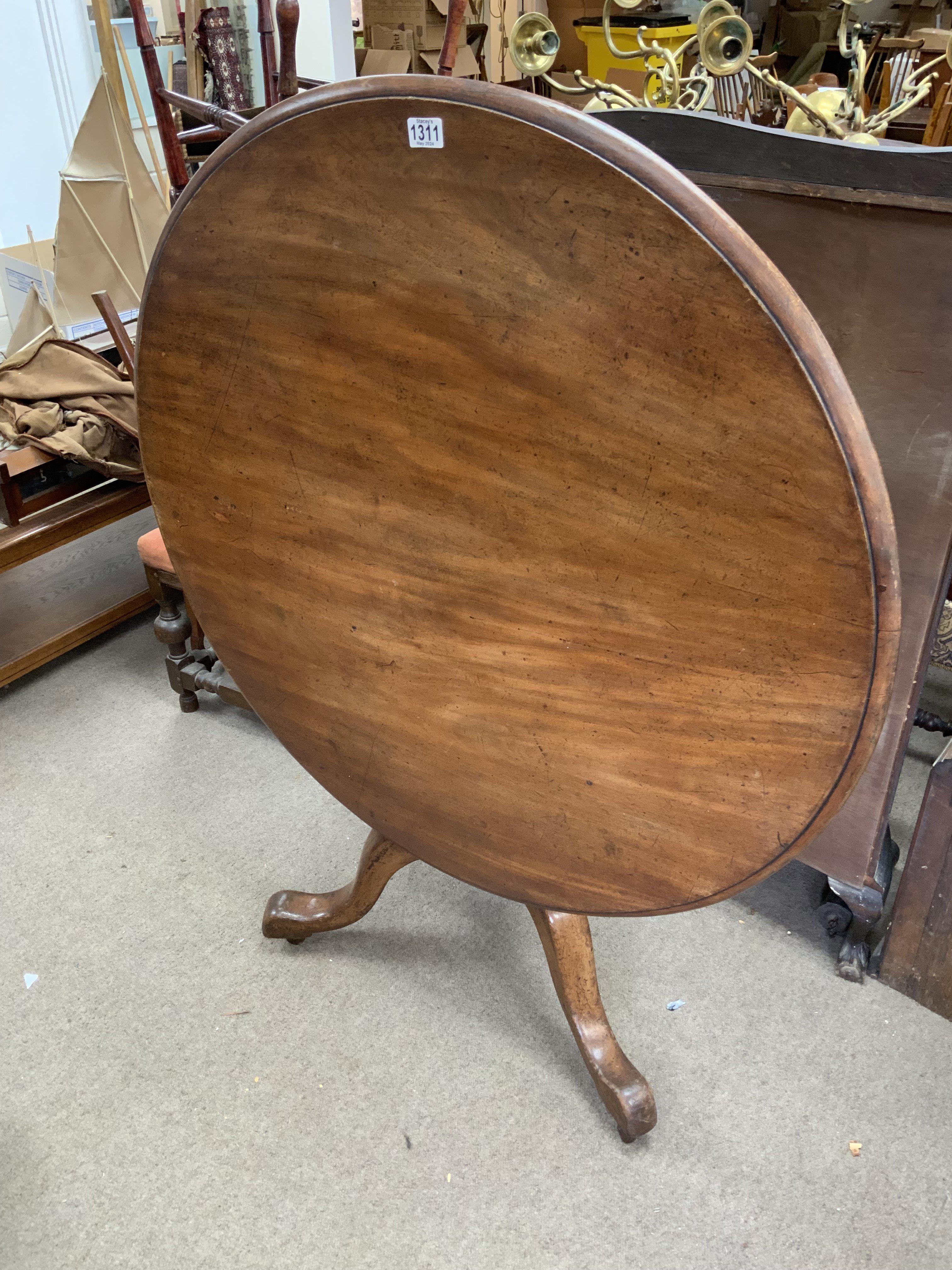 A circular topped mahogany breakfast table with ti