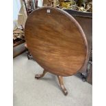 A circular topped mahogany breakfast table with ti
