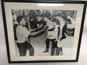 A framed, glazed and signed print of Muhammad Ali