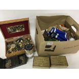 A box containing mix military buttons various colo