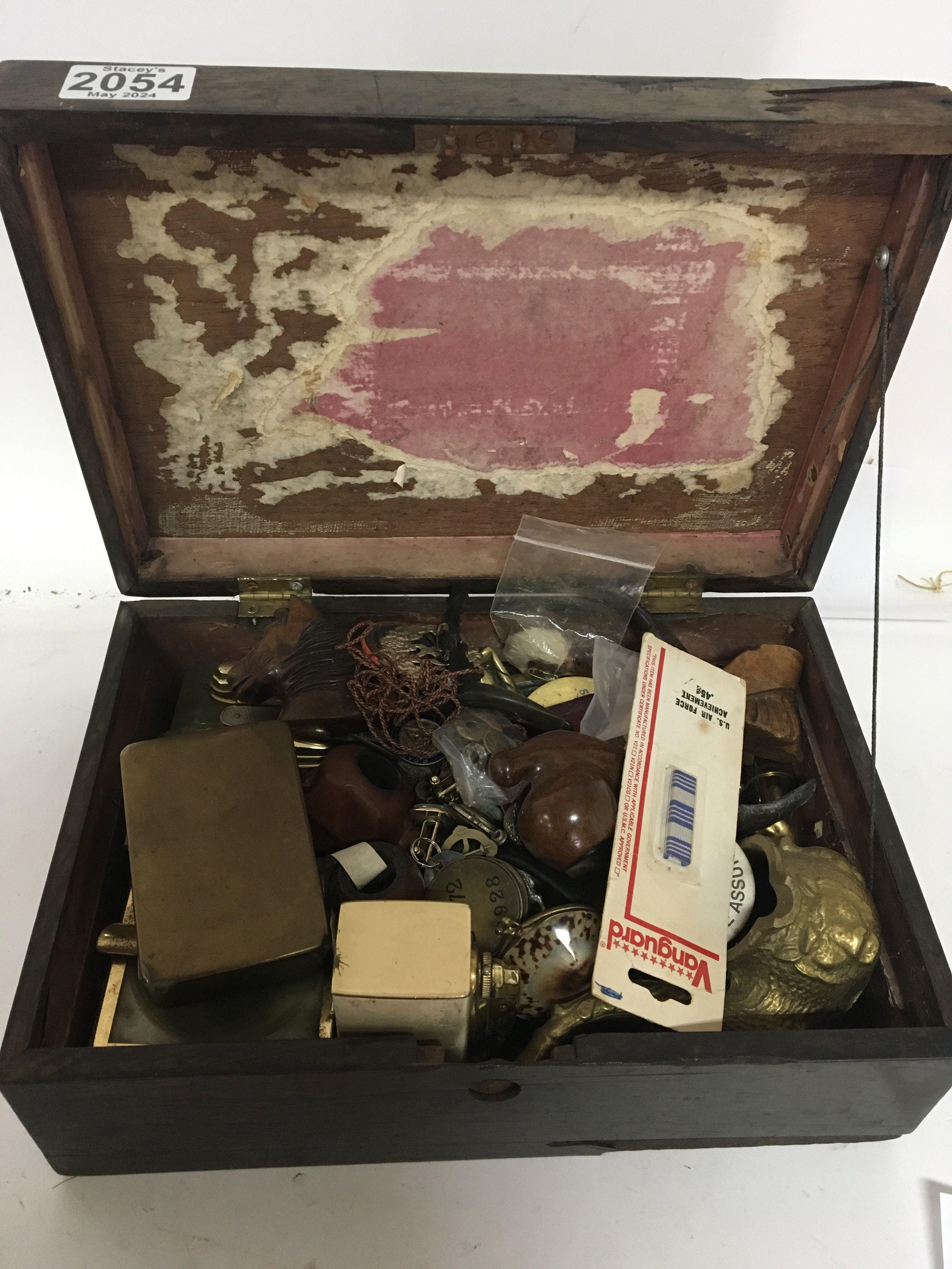 A box containing old smokers pipes lighters and ot