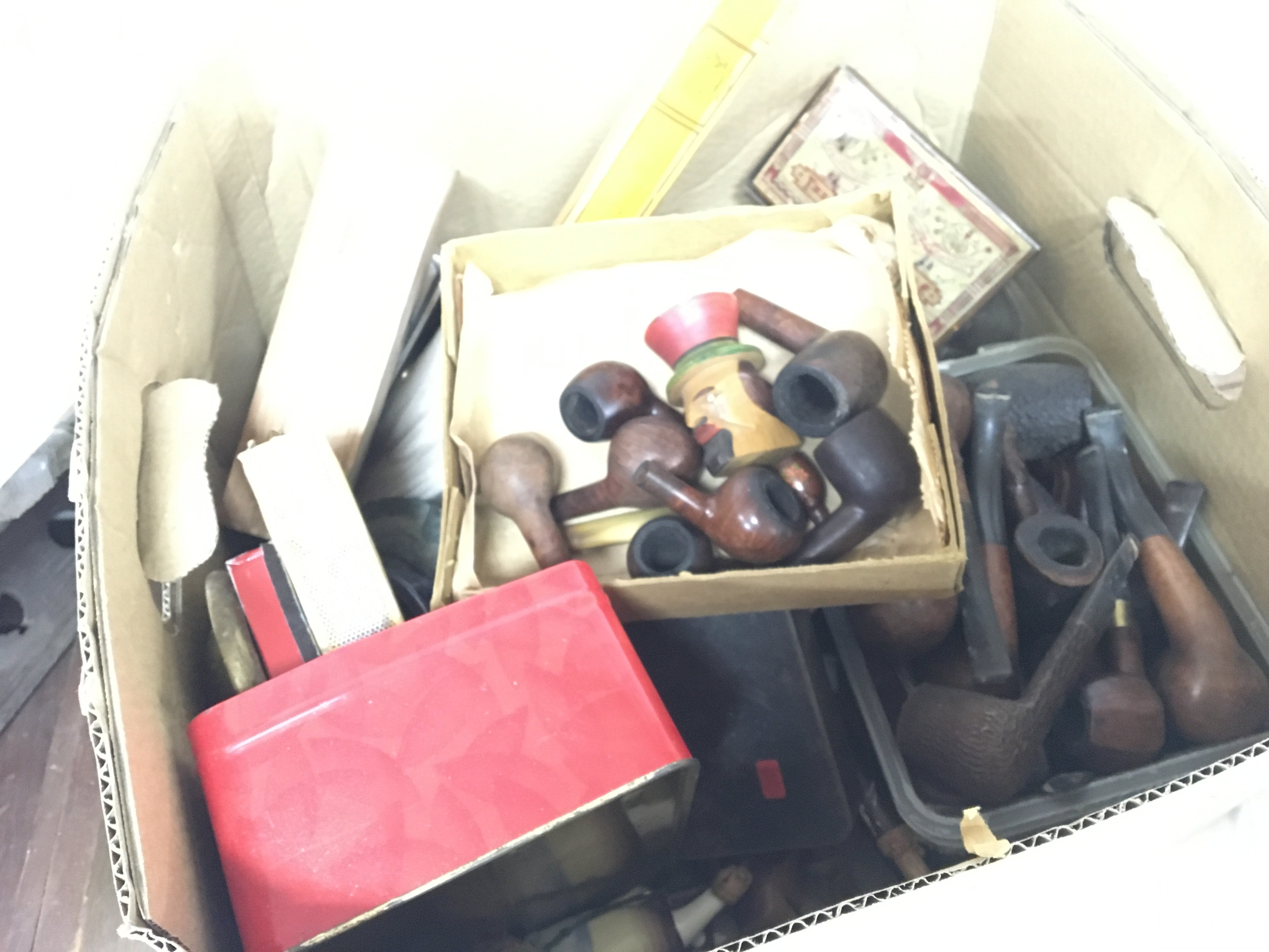 A box containing a large quantity of old pipes a f