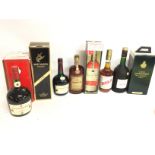 A collection of bottles including Courvoisier, Ama