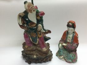 An Oriental figural lamp in the form of an elder,