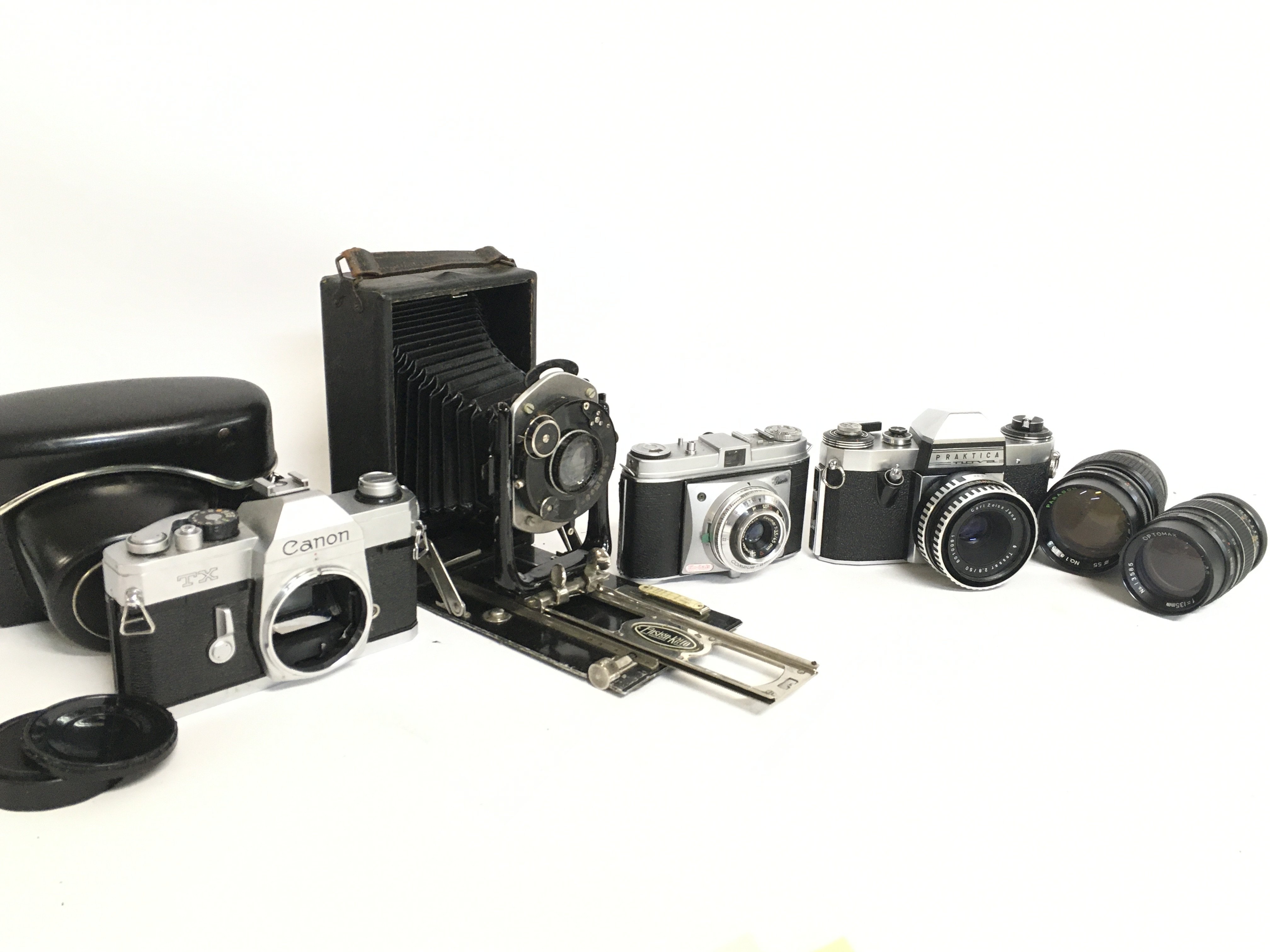 A collection of various cameras including a Canon