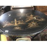 A oval occasional table with raised chinoiserie de