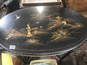 A oval occasional table with raised chinoiserie de