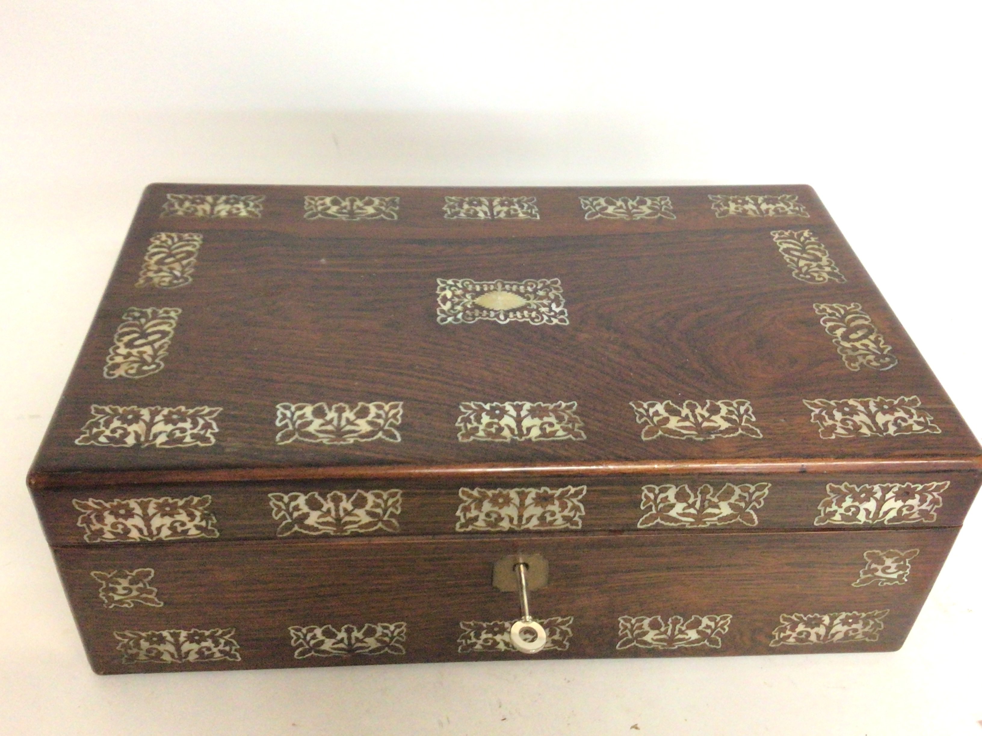 A rosewood mother of pearl inlaid writing box with