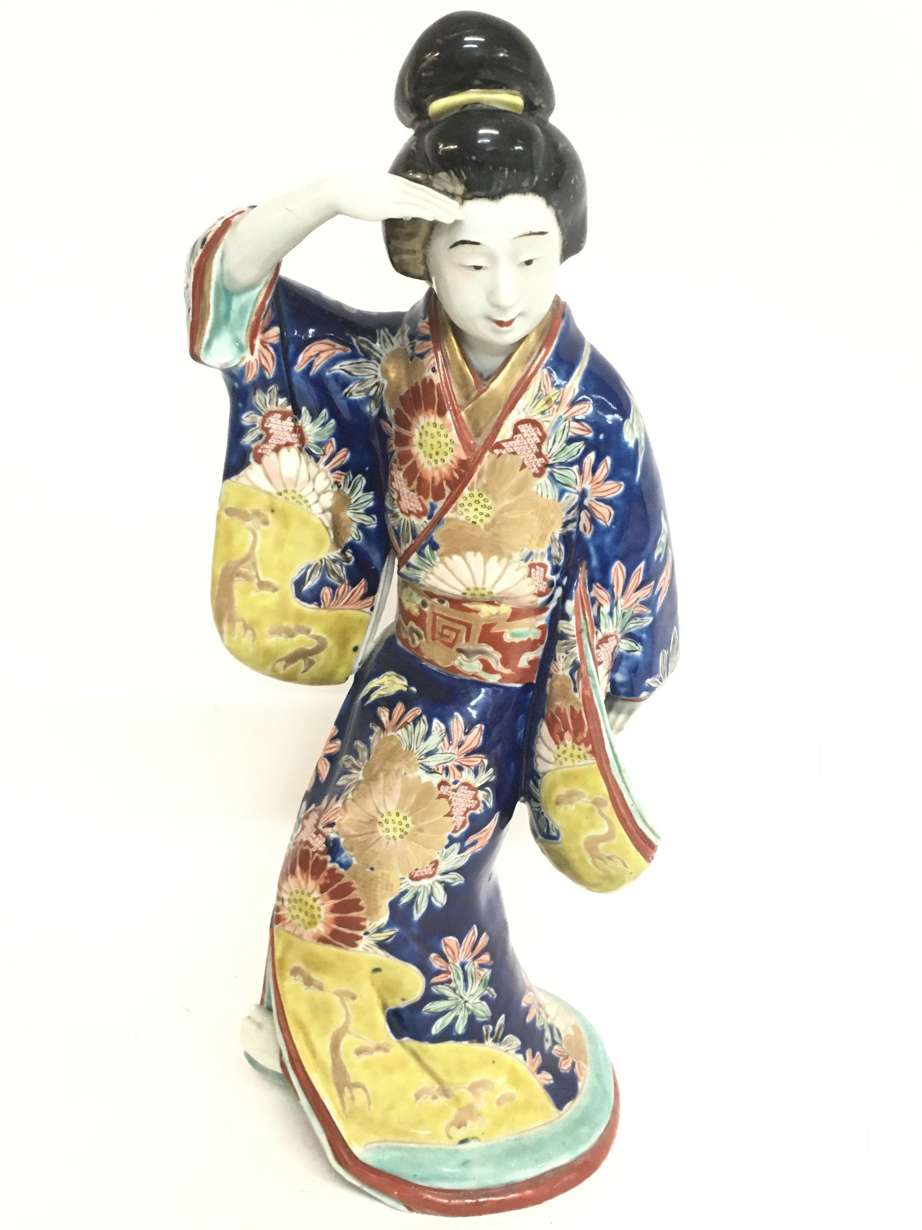 A large Japanese figure of a woman dressed in a ki